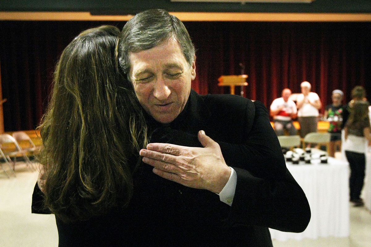 Bishop Blase Cupich hugs Erin Goetzinger at a reception following his farewell Mass at the Cathedral of Our Lady of Perpetual Help in Rapid City, S.D., on  Aug. 15. “He brought a little piece of heaven to the Hills,” Goetzinger said. “I will miss him sorely.”  (AARON ROSENBLATT)