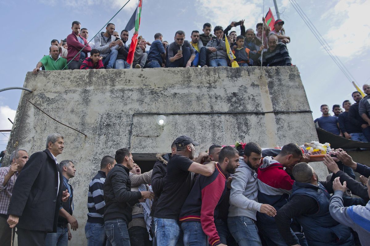 Mourners carry the body of Palestinian Mohammed Shreteh during his funeral in the West Bank village of Mazraa al-Gharbiya, near Ramallah, Sunday, Nov. 11, 2018. Shreteh succumbed to his wounds that were sustained during clashes with Israeli soldiers in the village last month. (AP Photo/Nasser Nasser) ORG XMIT: NN103 (Nasser Nasser / AP)