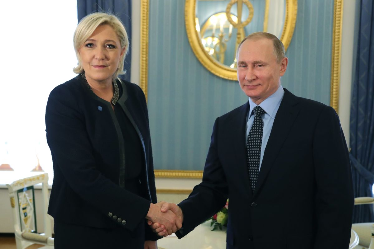 FILE - Russian President Vladimir Putin, right, shakes hands with French far-right presidential candidate Marine Le Pen, in the Kremlin in Moscow, Russia, Friday, March 24, 2017. France is thousands of miles from Ukraine, but what happens in French voting stations this month could have repercussions in Ukrainian battlefields. Nationalist candidate Marine Le Pen wants to halt arms supplies to Ukraine, improve Western ties with Russia and weaken the EU and NATO, which would undermine long-held Western alliances and efforts to stop the war  (Mikhail Klimentyev)