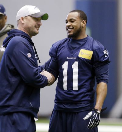 Seattle Seahawks WR Percy Harvin (11) shakes hands with special teams coordinator Brian Schneider at NFL football practice Tuesday, Jan. 7. (AP)
