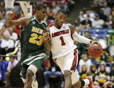 Associated Press Louisville’s Terrence Williams, bumping into Siena’s Edwin Ubiles, was the catalyst for the Cardinals’ comeback for a second-round victory. (Associated Press / The Spokesman-Review)