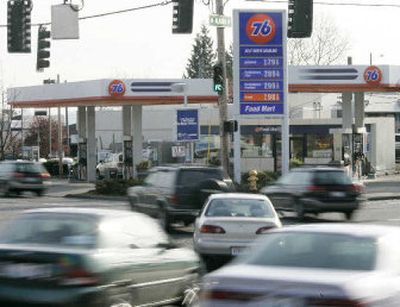 
Cars speed past a gas station Tuesday in West Seattle. Pump prices for gasoline are rising with the temperature and likely will average about 25 cents a gallon more than last summer, the government estimates.
 (Associated Press / The Spokesman-Review)