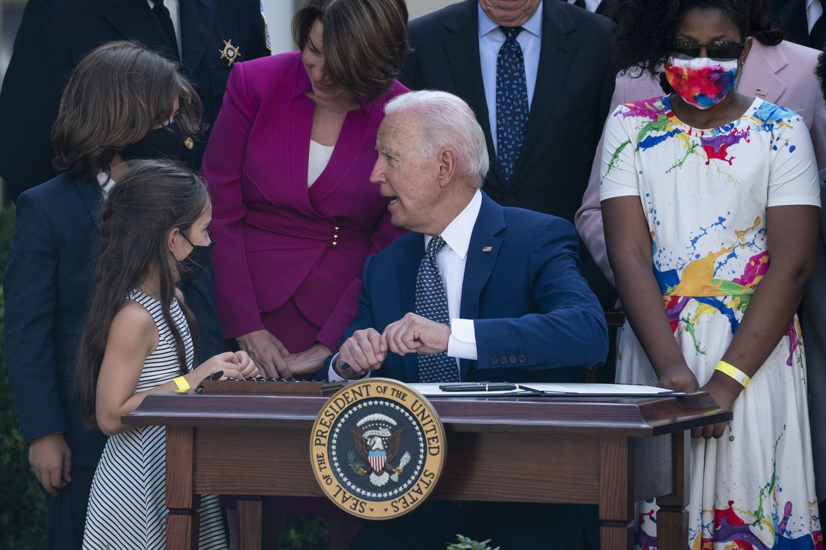 President Joe Biden talks with Logan Evans and Abigail Evans, children of USCP Officer William "Billy" Evans before signing a bill that awards Congressional gold medals to law enforcement officers that protected members on Congress at the Capitol during the Jan. 6 riots, in the Rose Garden of the White House, Thursday, Aug. 5, 2021, in Washington.  (Evan Vucci)