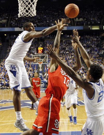Darius Miller, left, blocks Nurideen Lindsey of St. John’s on Thursday for one of Kentucky’s school-record 18 blocks. (Associated Press)