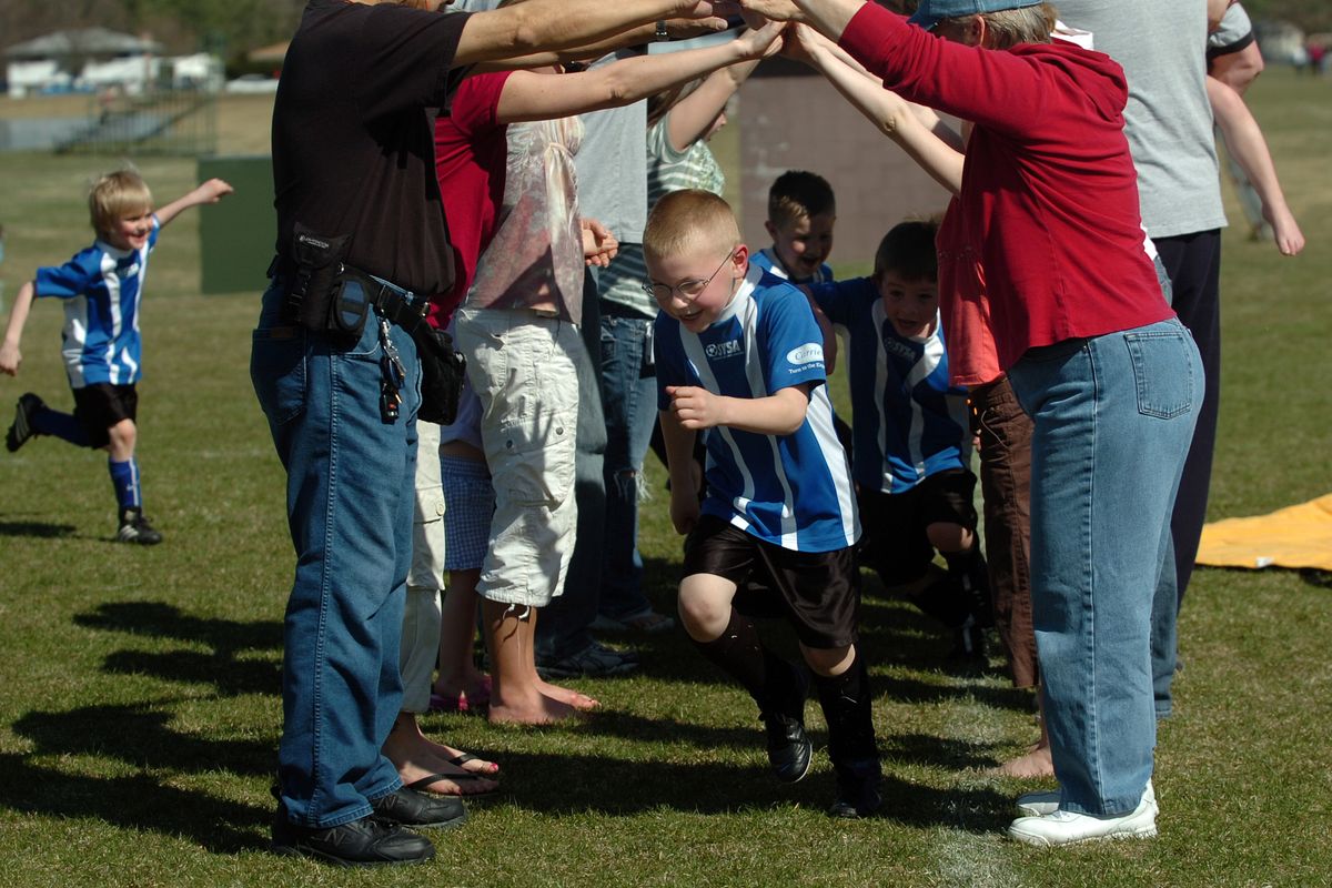 C.J. Niska runs out of a tunnel of parents’ arms after a Spokane Youth Sports Association game at Farwell Road field complex in this April 2008 photo. The nonprofit SYSA has plans to build a sports complex with four baseball and two multiuse fields in the rural area of 37th Avenue and Glenrose Road on the upper South Hill.  (JESSE TINSLEY)