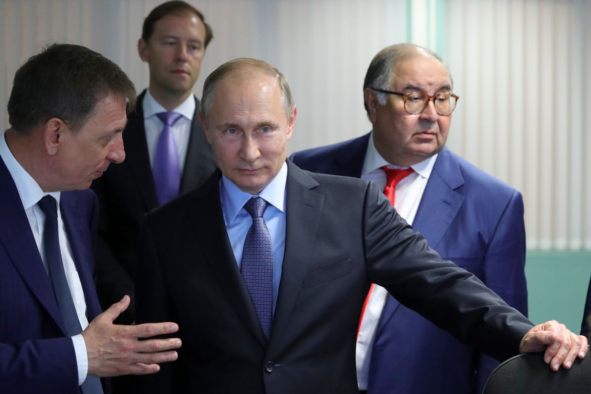 FILE - Russian President Vladimir Putin, center, listens to Lebedinsky GOK Managing Director Oleg Mikhailov, left, as businessman and founder of USM Holdings, Alisher Usmanov, right, and Minister of Industry and Trade Denis Manturov stand behind him while visiting the Lebedinsky GOK JSC, in Gubkin, Belgorod Region, Russia, Friday, July 14, 2017. Usmanov is not on the sanctions list implemented in response to the 2022 invasion of Ukraine. The metals tycoon was an early investor in Facebook. His fortune is estimated at more than $14 billion.  (Mikhail Klimentyev)