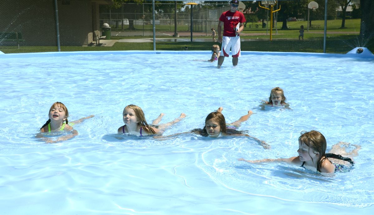 Lifeguard Nick Kruiswyk keeps a close eye on children enjoying the reopened Millwood wading pool Thursday. (Dan Pelle)