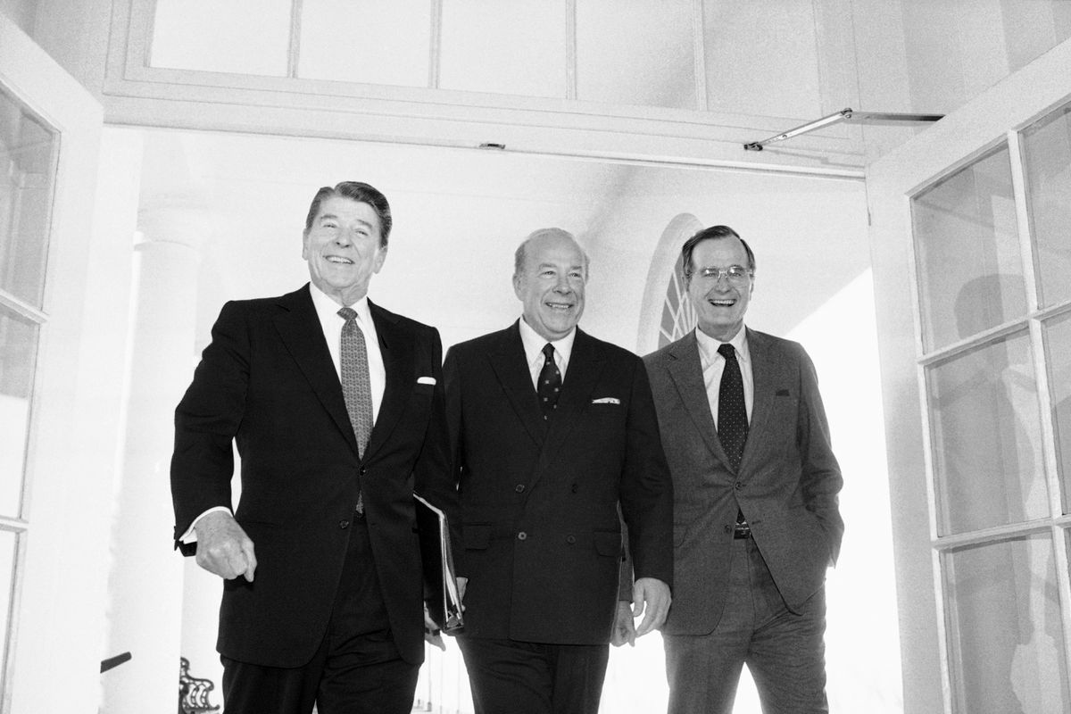 FILE - In this Jan. 9, 1985 file photo, Secretary of State George Shultz, center, walks with President Ronald Reagan and Vice President George Bush upon his arrival at the White House in Washington, after two days of arms talks with the Soviet Union in Geneva. Shultz, former President Reagan