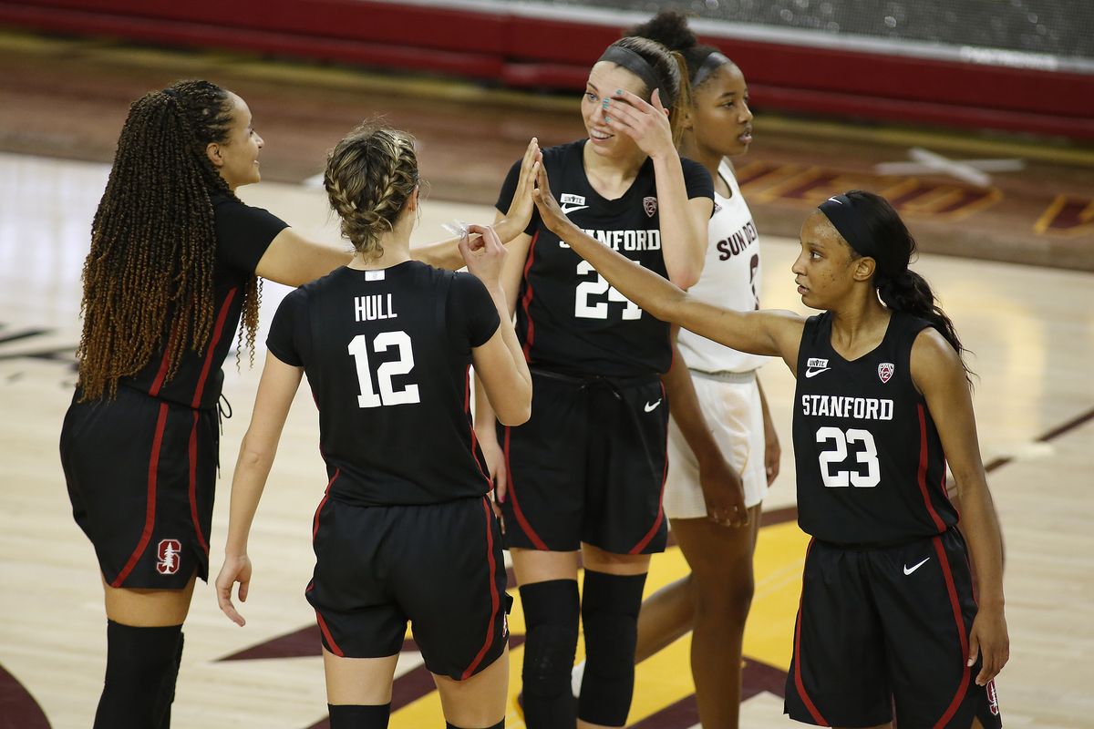 Stanford’s Lexie Hull (12) and Lacie Hull, second right, celebrate with teammates late in the game during their Jan. 3 win at Arizona State.  (Associated Press)