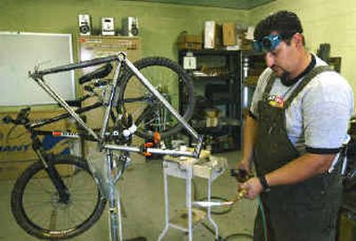 
Oscar Camarena works on a bike frame for his business in his Zillah, Wash., shop. 
 (Associated Press / The Spokesman-Review)