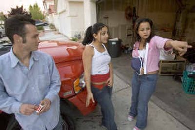 
Genesis Reyes, 13, right, describes how police detained her and allegedly hurt her arm as they executed a search warrant at the Las Vegas home of her mother, Anna Ayala, on Thursday. Looking on are family friend Ken Bono, 24, who lives at the residence, and cousin Priscilla Chavarin, 16. 
 (Associated Press / The Spokesman-Review)