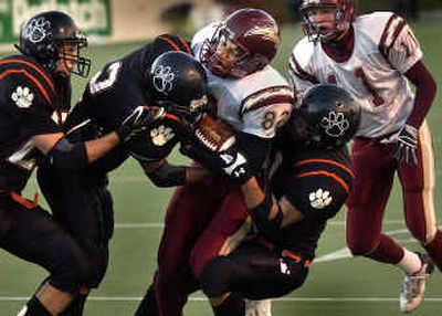 
University wide receiver Ian Williamson (82) powers ahead for a second-quarter first down against Lewis and Clark. The Titans held on for a 17-14 victory over the Tigers. 
 (Brian Plonka / The Spokesman-Review)