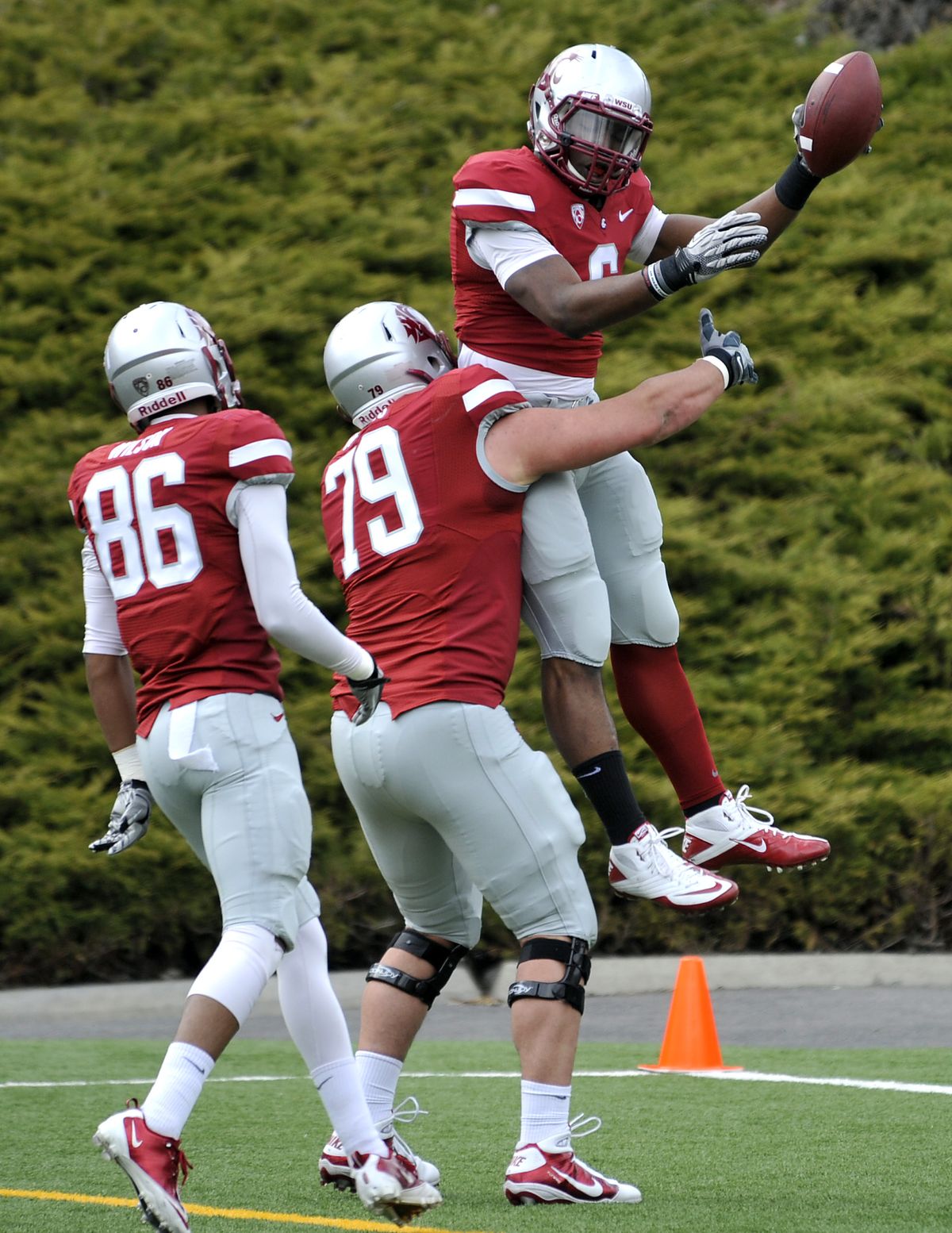 Washington State University running back, Logwone Mitz (6), leaps into the arms of lineman, David Gonzales, after Mitz scored on a long run during the WSU spring scrimmage, April 16, 2011, at Joe Albi Stadium in Spokane, Wash. (Dan Pelle / The Spokesman-Review)