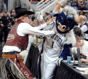 ORG XMIT: UTLHJ501 ** FILE ** In this March 13, 2009, file photo, New Mexico State mascot Pistol Pete, left, chokes Utah State mascot Big Blue after Pistol Pete had his mustache ripped off by Big Blue during a timeout in an NCAA college basketball game in the Western Athletic Conference men's tournament in Reno, Nev. Pistol Pete was given a one-game suspension by the WAC on Monday, March 30, 2009, for his involvement in the incident. (AP Photo/The Herald Journal, Eli Lucero, File) (Eli Lucero / The Spokesman-Review)