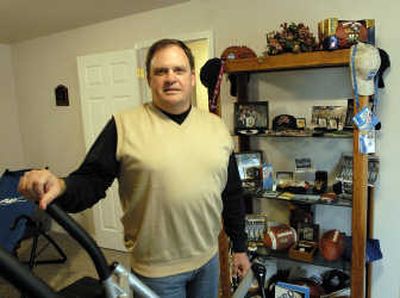 
Steve Wilson, a National Football League umpire and executive pastor of Spokane Valley Nazarene Church, poses at home in his workout-memorabilia room. 
 (J. BART RAYNIAK / The Spokesman-Review)
