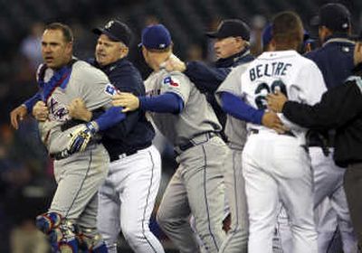 
Rangers catcher Gerald Laird, left, is restrained by John McLaren.Associated Press
 (Associated Press / The Spokesman-Review)