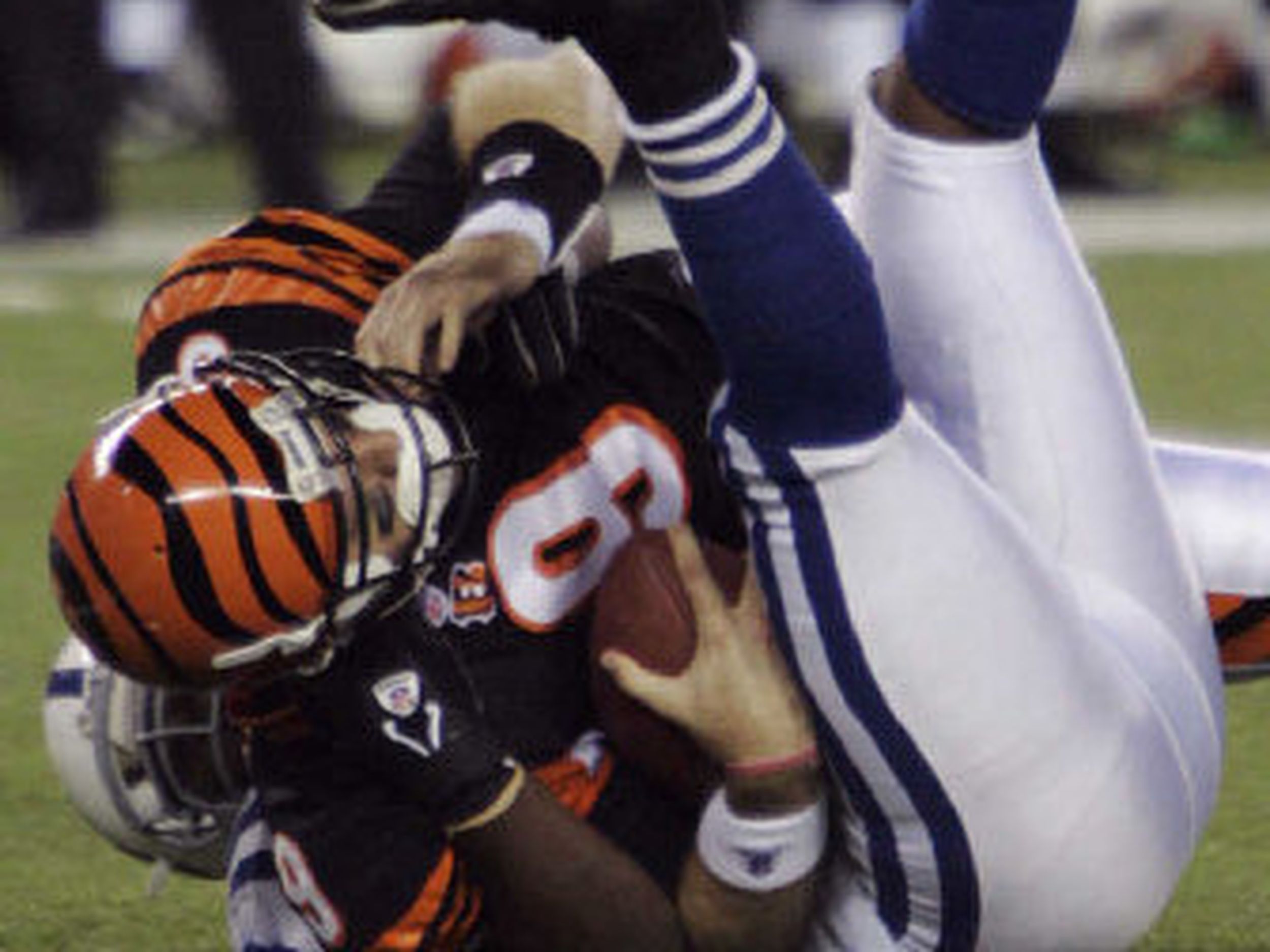 Cincinnati Bengals running back Rudi Johnson looks to fend off a