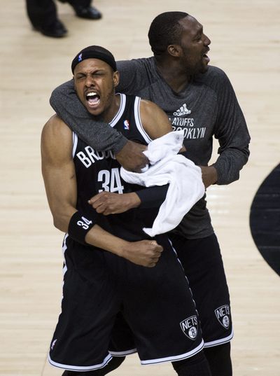 Nets’ Paul Pierce (34) celebrates with teammate Andray Blatche after a game- and series-clinching block on Toronto’s Kyle Lowry. (Associated Press)