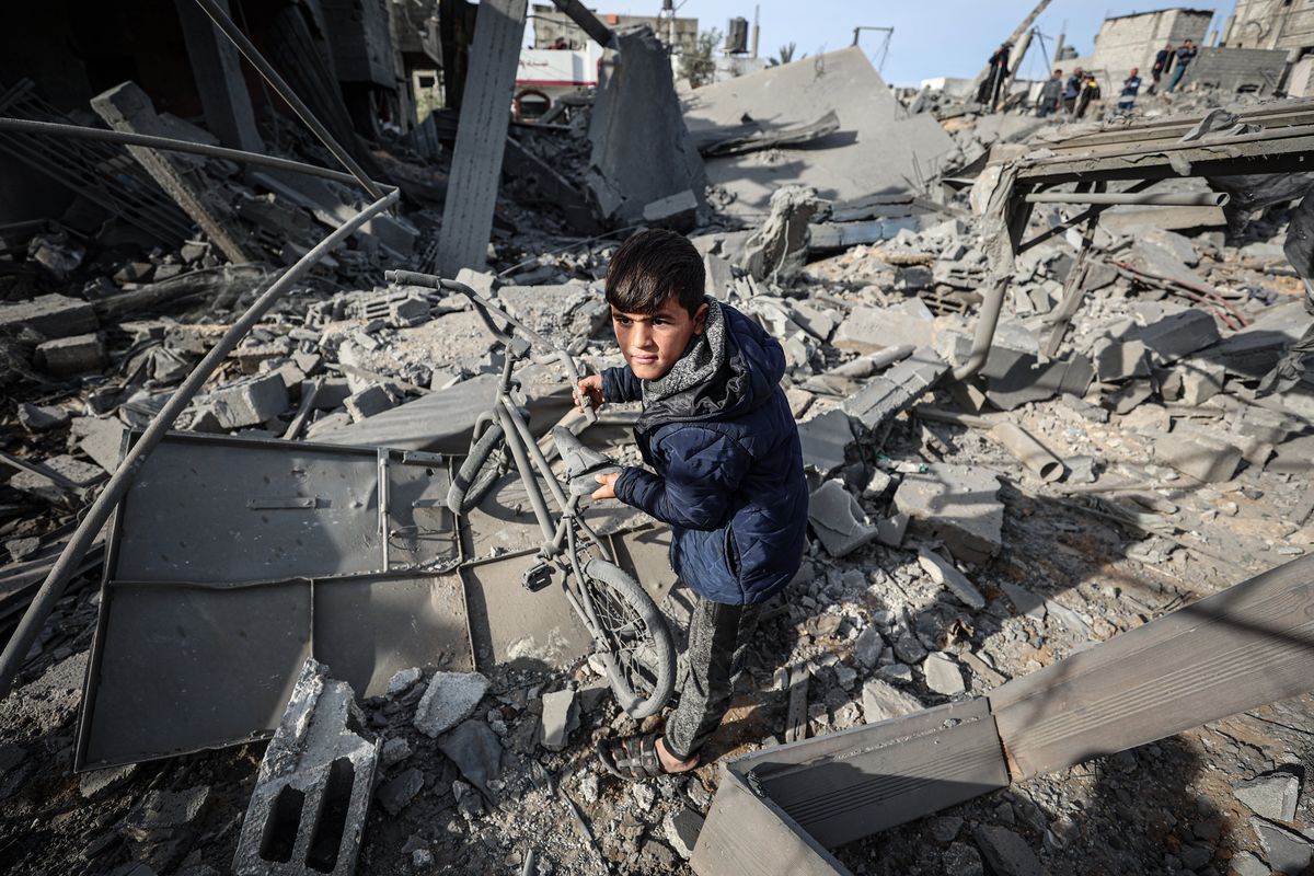 Palestinians inspect their destroyed homes after an Israeli airstrike killed more than 60 people in Rafah, southern Gaza Strip.    (Loay Ayyoub/for The Washington Post)