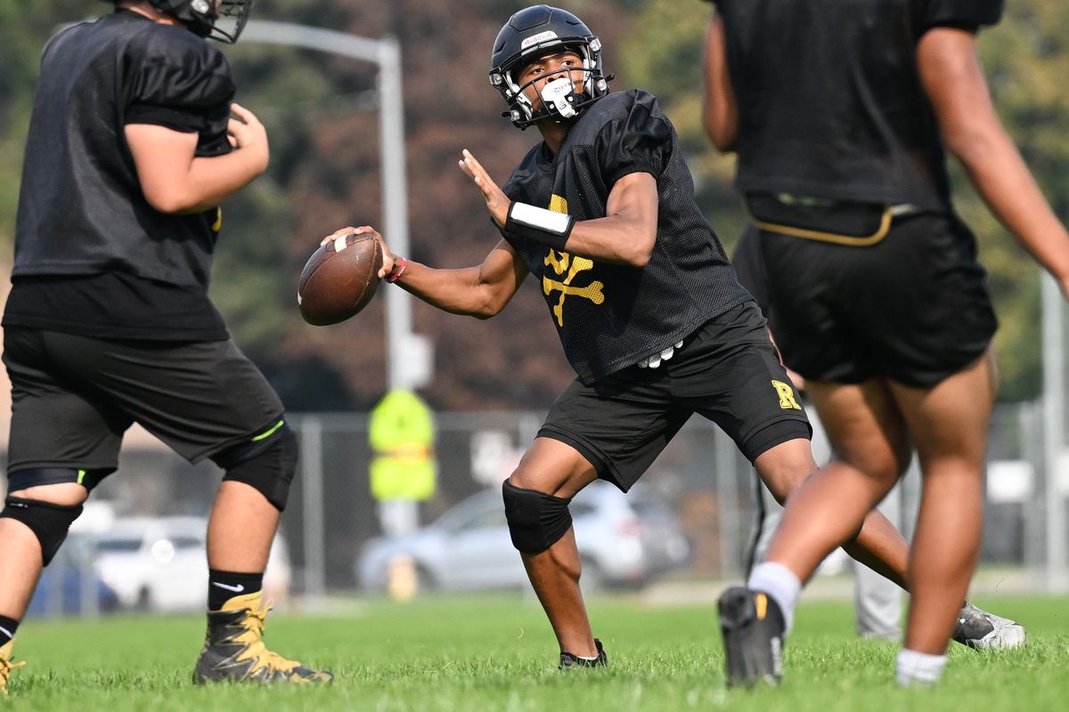 Rogers quarterback Deon Kinsey throws during practice on Wednesday at Rogers High School.  (Tyler Tjomsland/The Spokesman-Review)