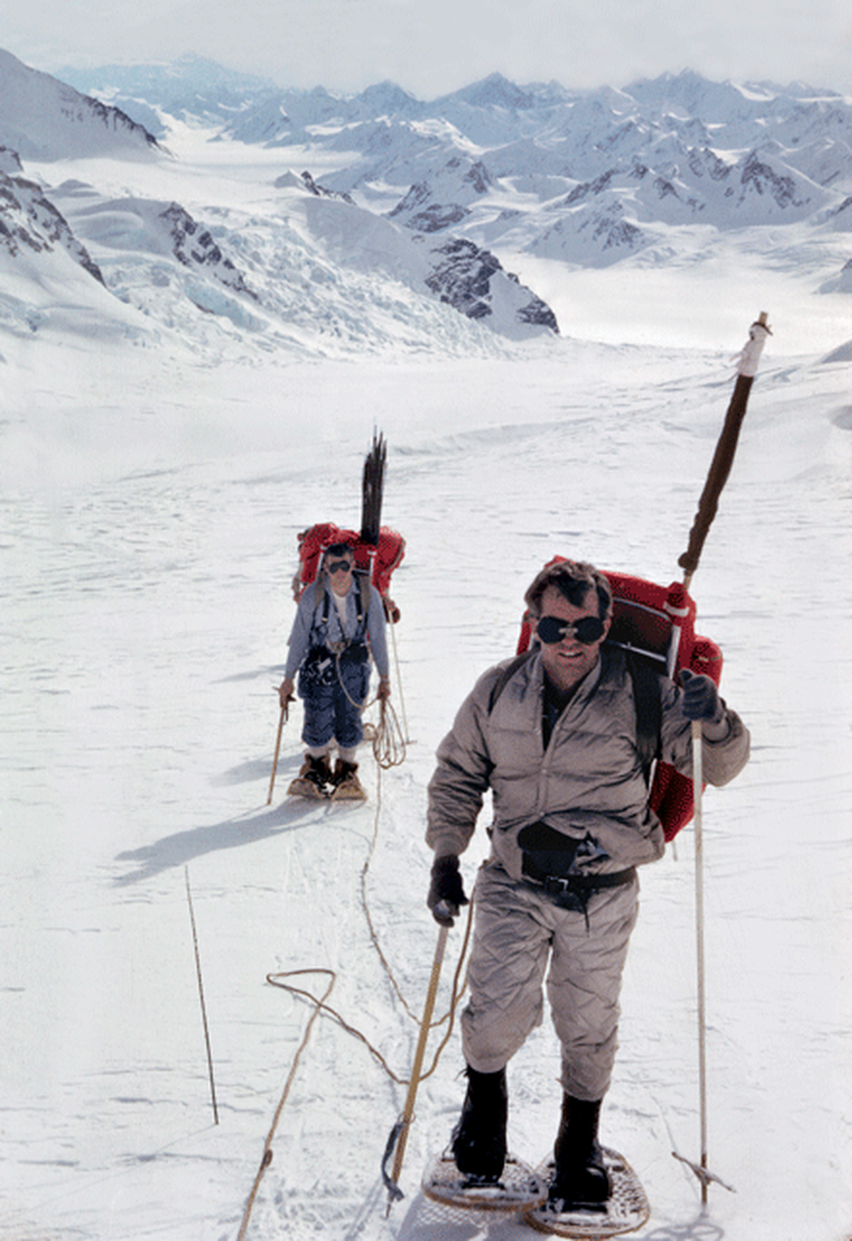 Robert Kennedy and Barry Prather traverse the Cathedral Glacier en route to the base of Mount Kennedy in March 1965. In a climb led by Jim Whittaker, RFK would become the first person to reach the summit of the  Canadian peak named in memory of his brother, President John F. Kennedy. Poking out of their backpacks are wands they could use to mark their return route on the featureless glacier in the case of a whiteout.
 (Jim Whittaker / Whittaker Family Collection)