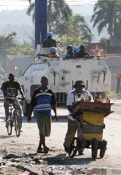 
United Nations peacekeepers from Brazil and Haitian police patrol a street in an armored vehicle in Port-au-Prince on Friday. 
 (Associated Press / The Spokesman-Review)