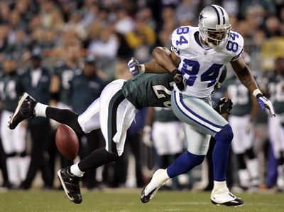 Eagles free safety Brian Dawkins breaks up a pass intended for Cowboys receiver Patrick Crayton (84).  (Associated Press / The Spokesman-Review)