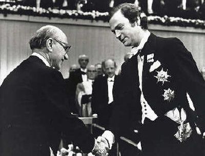 
Milton Friedman, left, winner of the Memorial Prize in Economics, grips the hand of Sweden's King Carl Gustaf as he receives his award in Stockholm, in 1976. 
 (Associated Press photos / The Spokesman-Review)