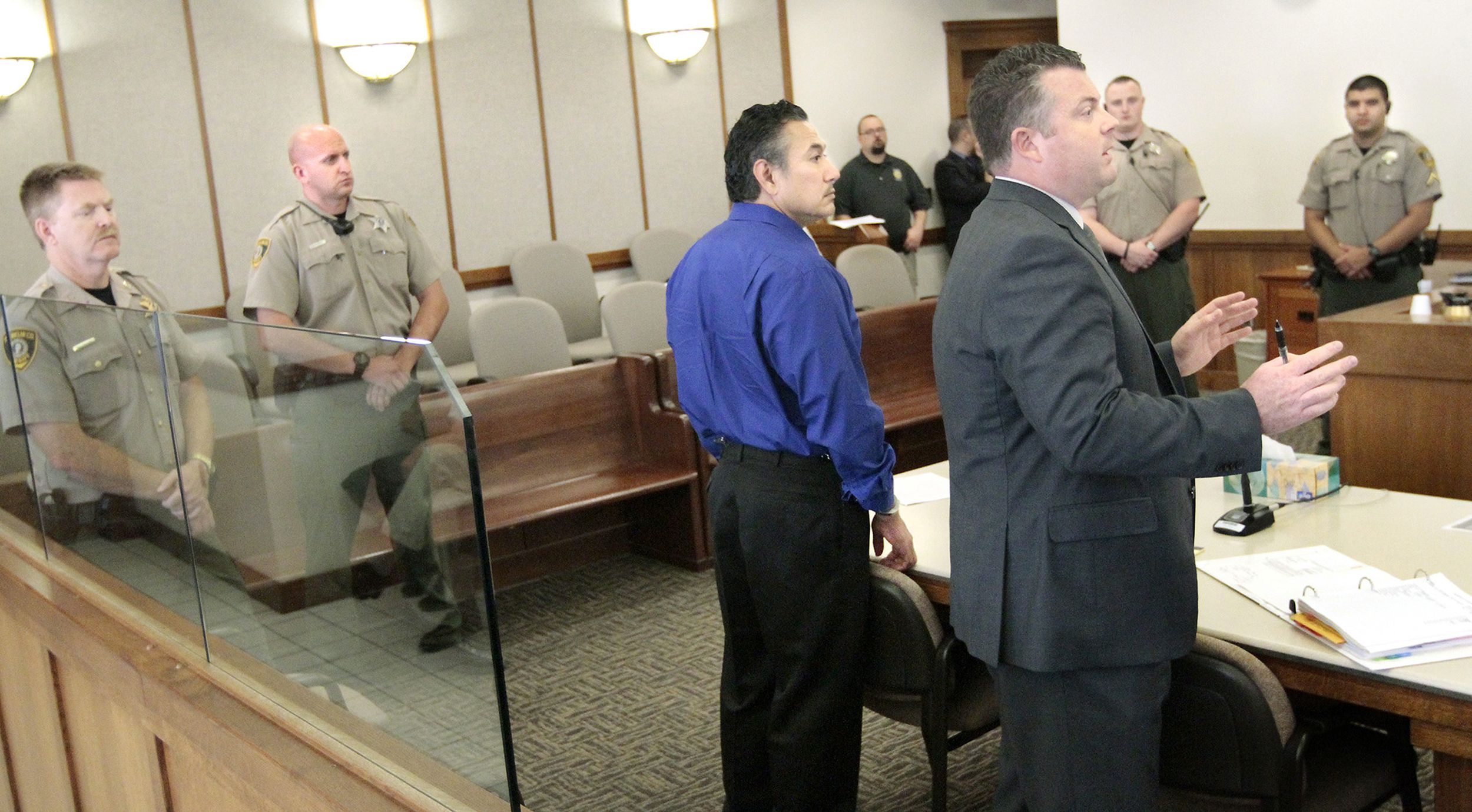 ExPasco officer charged with tampering with a witness in murder trial