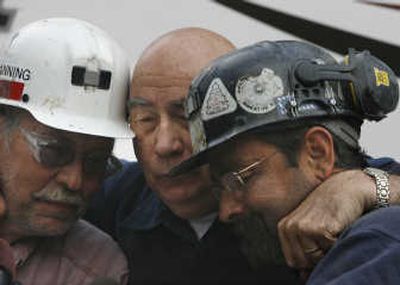 
Bob Murray, center, chairman of Cleveland-based Murray Energy Corp., embraces Dave Canning, left, and Mike Glassom, two miners in charge of drilling boreholes.Associated Press
 (Associated Press / The Spokesman-Review)