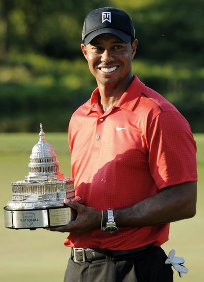 Tiger Woods poses with trophy after winning the AT&T National. (Associated Press)