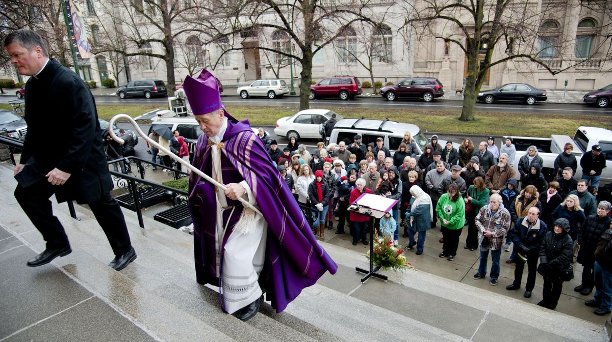 The Rev. Darrin Connall, left, and Bishop Blase Cupich climb the stairs of the Cathedral of Our Lady of Lourdes on Friday after a gathering to remember the 26 victims of the Sandy Hook Elementary School shooting in Newtown, Conn. (Dan Pelle)