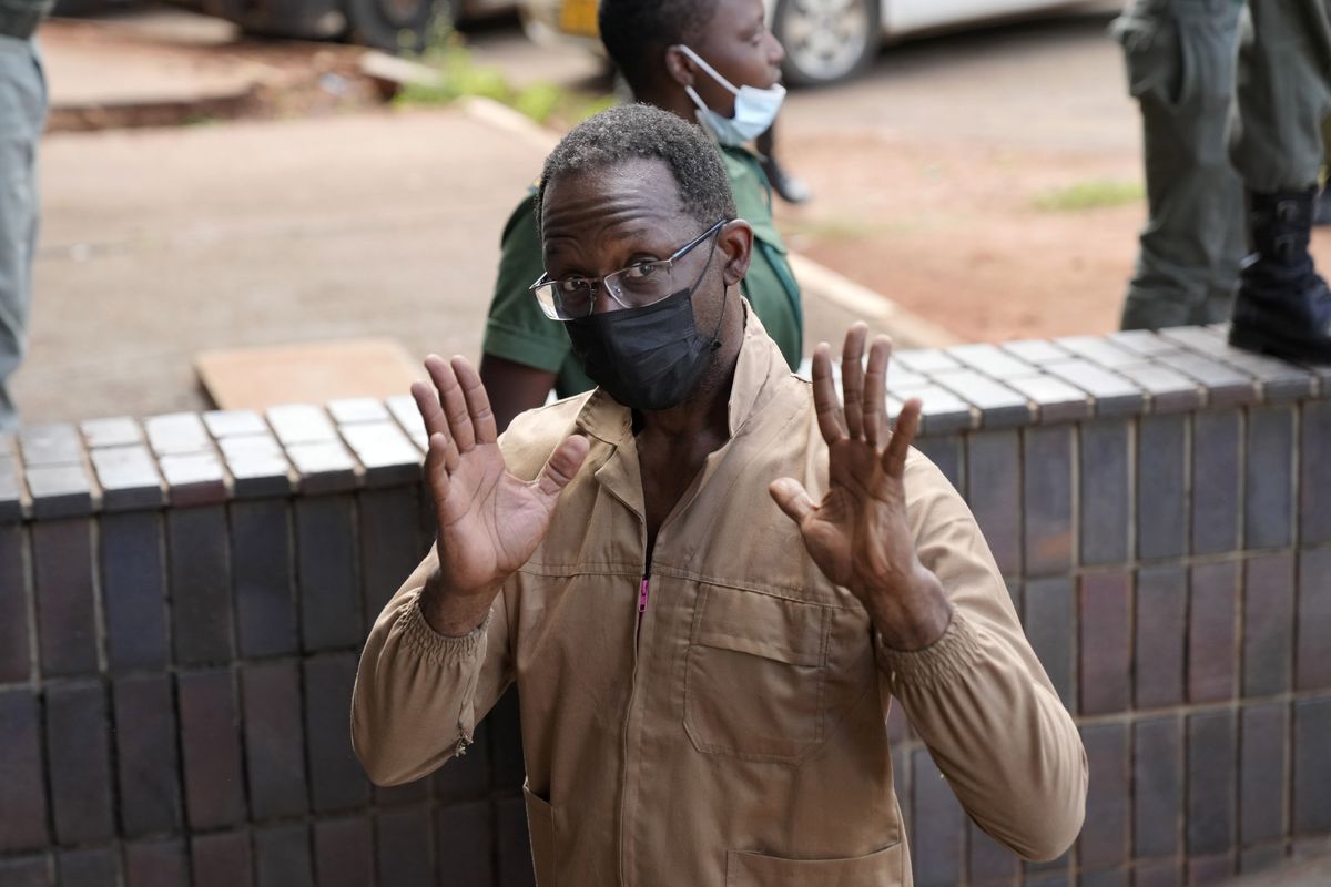 Retired U.S. Army soldier Ronald Leon Johnson arrives to make his court appearance at the magistrates courts in Harare, Zimbabwe, Wednesday, Feb, 23, 2022. Johnson was arrested and has been in detention in Zimbabwe for a week charged with trying to board a plane with a loaded and unregistered pistol, state media reported Tuesday. Johnson was arrested Feb. 15 as he checked in at Robert Mugabe Airport in the capital, Harare, for a flight to the tourist town of Victoria Falls, The Herald newspaper reported.  (Tsvangirayi Mukwazhi)