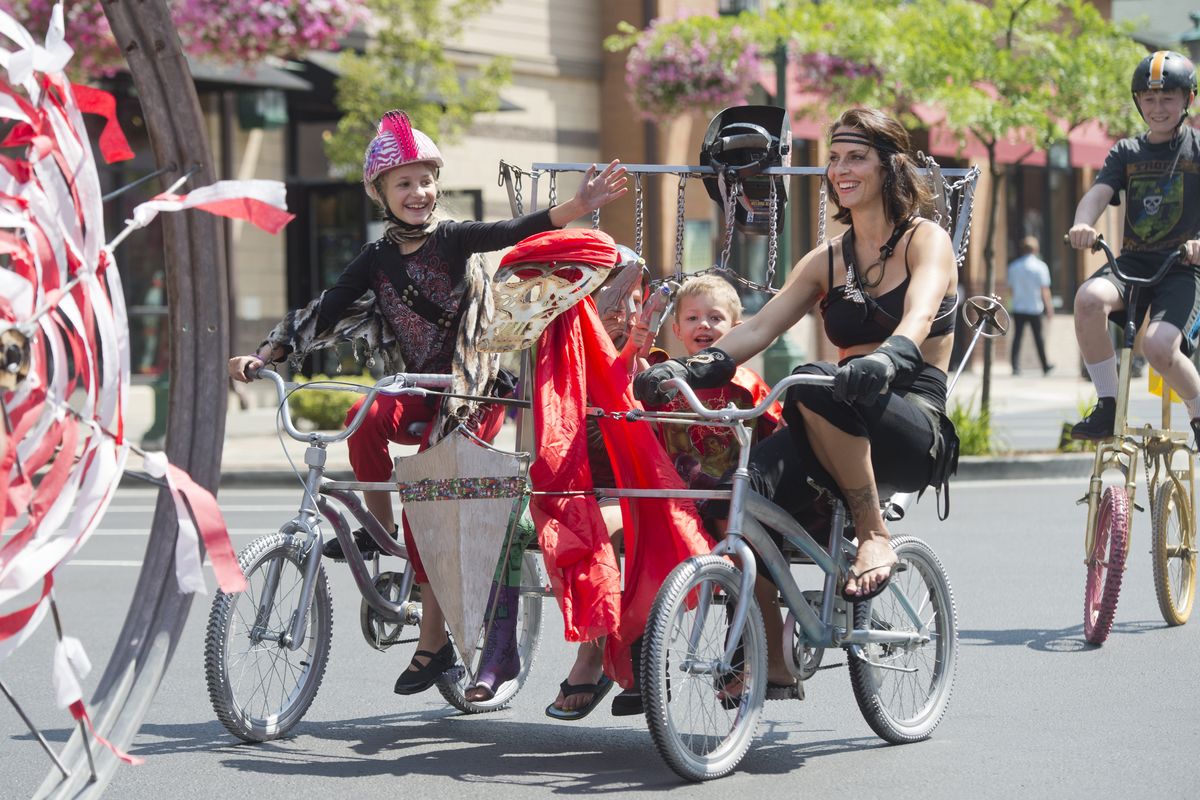 Jen Bokma, right, rides a double bicycle creation she made with her kids, from left, Karis, 9; Liam, 7; and Waylon, 5, in the parade Sunday at Kinetic Fest. Bokma learned to weld in a special class just for women at Gizmo in Coeur d’Alene.