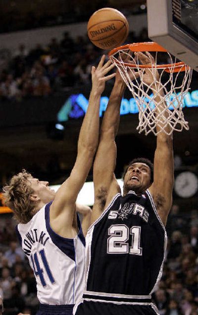 
San Antonio's Tim Duncan, right, loses control of the ball as he is fouled by Dallas' Dirk Nowitzki. 
 (Associated Press / The Spokesman-Review)