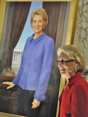 Gov. Chris Gregoire stands next to her official portrait by artist Michele Rushworth after it was unveiled Jan. 11, 2013, in the Capitol Reception Room. It will hang in the lobby of the governor's office. (Jim Camden)