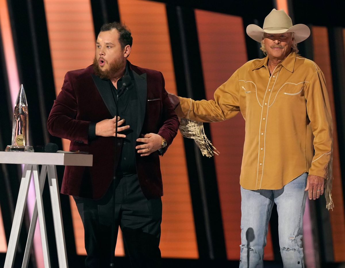 Luke Combs, left, accepts the award for entertainer of the year as presenter Alan Jackson looks on at the 55th annual CMA Awards on Wednesday at the Bridgestone Arena in Nashville, Tenn.  (Mark Humphrey)