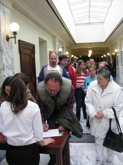 Hundreds wait in line to sign up to testify on proposed Medicaid cuts at a public hearing on Tuesday afternoon, even as the hearing begins. (Betsy Russell)
