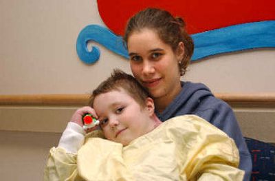 Theresa Ashmore with her 5-year-old son Brian at Seattle Children's Hospital prior to his release Friday. Brian was to return to the family's Spokane home for the first time since being burned in June.
(Richard Roesler/ / The Spokesman-Review)