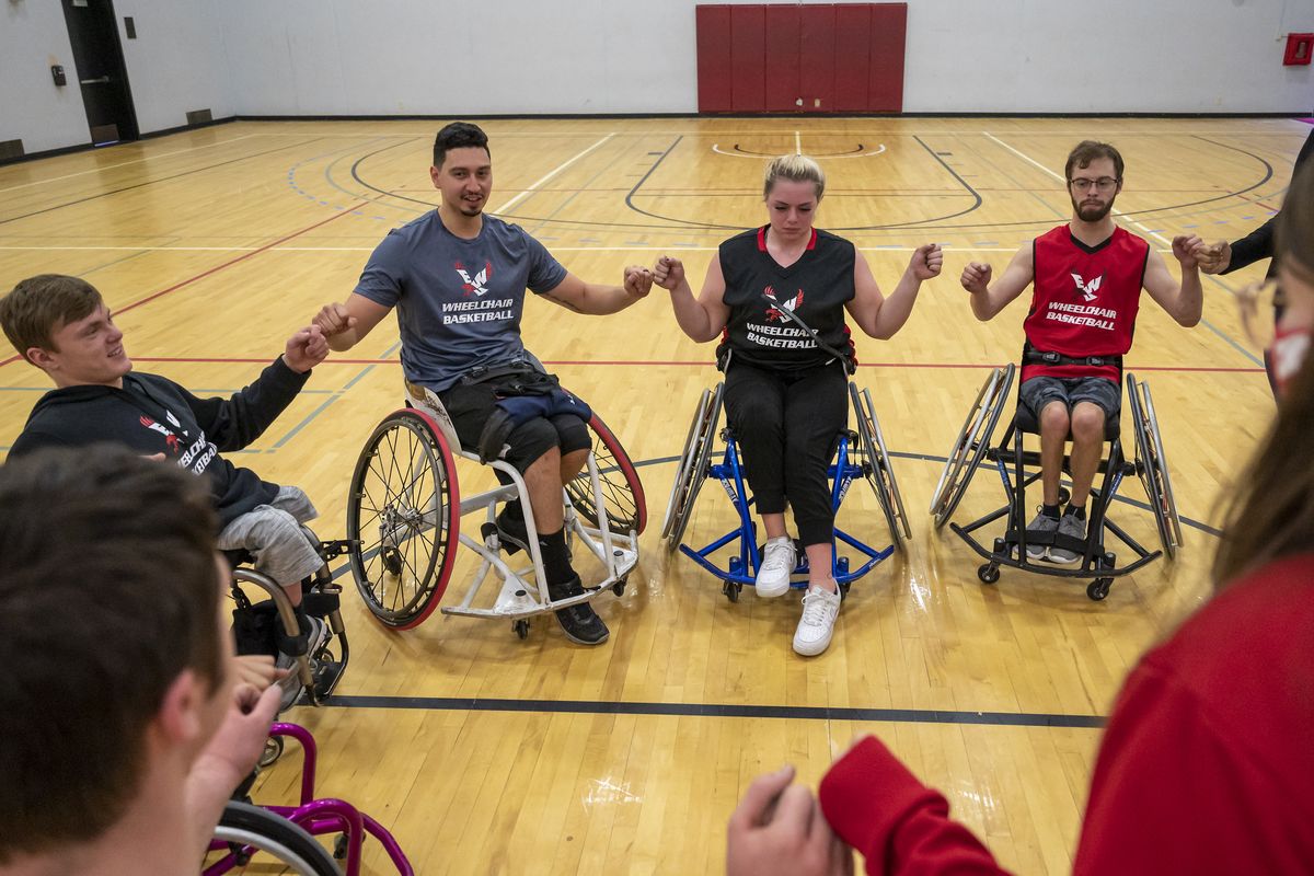 Coach David Evjen (in white wheelchair) gathers players together after a scrimmage at Eastern Washington University, Friday, Nov. 20, 2020. The Inland Northwest has had several standout wheelchair athletes – each in a wheelchair for various reasons – but never a collegiate outlet. Now they do with EWU’s school-sponsored wheelchair basketball program. (Colin Mulvany/THE SPOKESMAN-REVIEW)