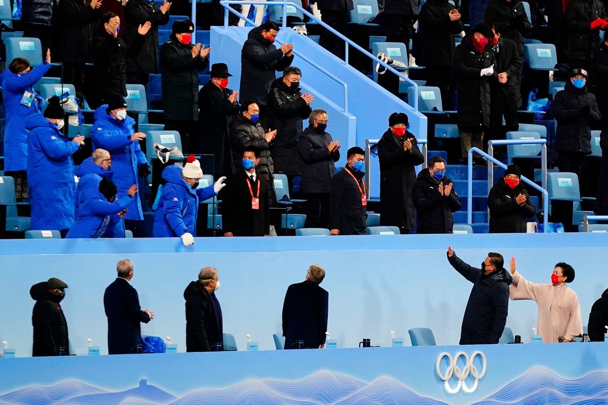 Chinese President Xi Jinping, bottom second from right, waves as he arrives for the opening ceremony of the 2022 Winter Olympics on Friday in Beijing.  (Matt Slocum)