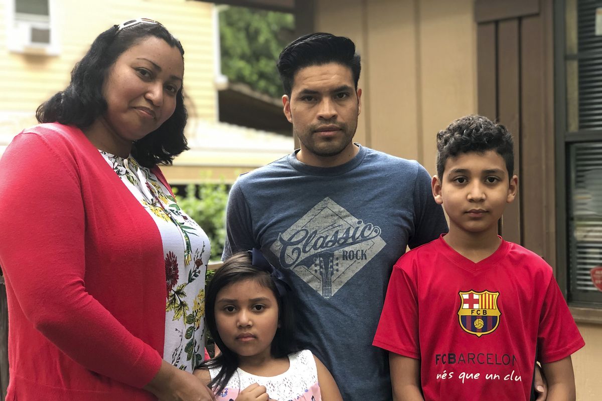 In this Thursday, June 18, 2020, photo, Lidia, from left, Vanessa, Guillermo and David Reyes pose for a photo in Durham, N.C. Grappling with the economic fallout of the coronavirus, the family sought help from loved ones and a local church to keep food on the table and pay their home bills.  (Bryan Anderson)