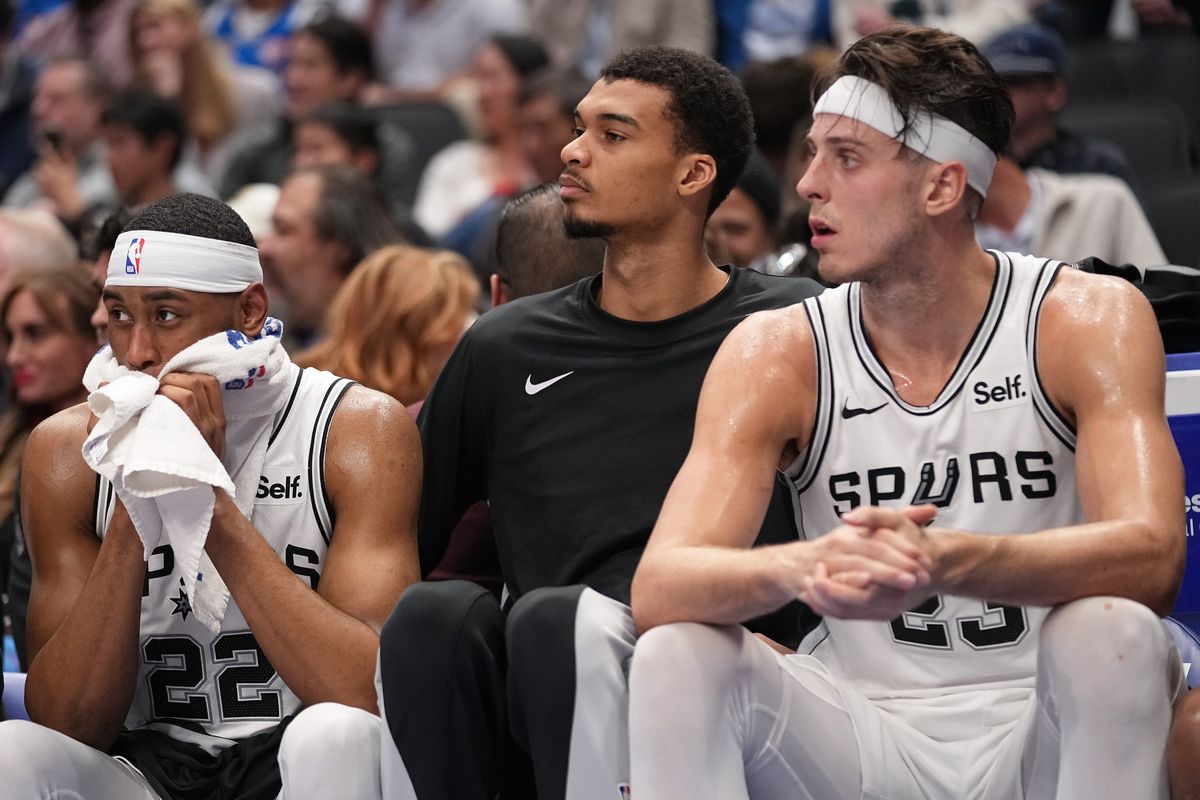 Zach Collins, right, sits with NBA Rookie of the Year Victor Wembanyama during a game on Dec. 23 in Dallas.  (Getty Images)
