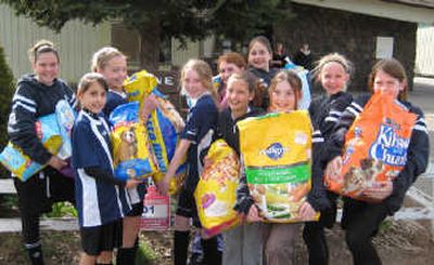 
Holly Jean Anderson, back row, fourth from right, and her friends donated bags of pet food to the Humane Society on April 23, her 11th birthday. Courtesy of Lynda Haisley
 (Courtesy of Lynda Haisley / The Spokesman-Review)