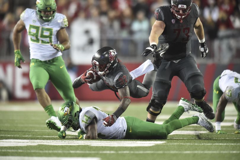 Washington State Cougars running back James Williams (32) flies over the Oregon defense during the second half of a college football game on Saturday, Oct 1, 2016, at Martin Stadium in Pullman, Wash. WSU won the game 51-33. (Tyler Tjomsland / The Spokesman-Review)