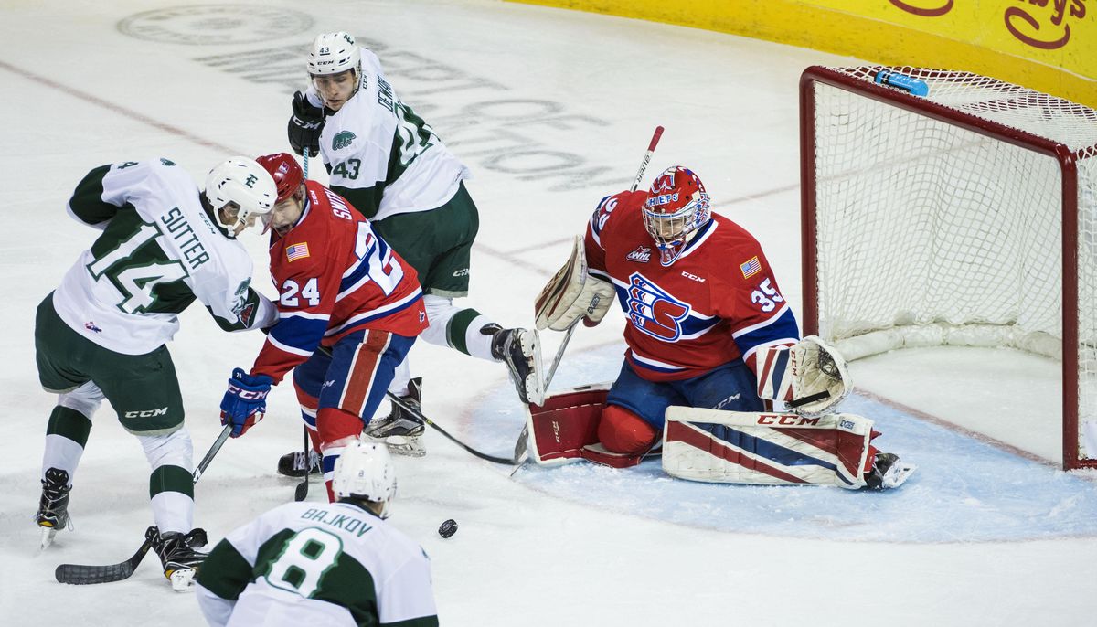 Spokane Chiefs’ Ty Smith (24) and goalie Donovan Buskey (35) defend a shot by Everett Silvertips’ Riley Sutter (14) in the first period, Friday, Dec. 15, 2017, in the Spokane Arena. (Dan Pelle / The Spokesman-Review)