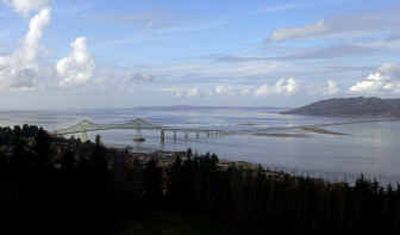 
The Columbia River flows past Astoria, Ore., under the bridge connecting Oregon, left, and Washington, right. The U.S. Army Corps of Engineers wants to deepen the river channel by 3 feet from Astoria to Vancouver, Wash.
 (File/Associated Press / The Spokesman-Review)