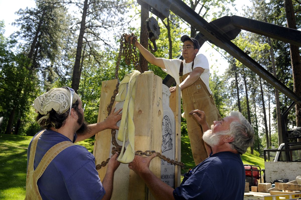 Aaron Kannegaard, left, Mike Morlan, center, and Dick Tresko  maneuver the Washington monument into its new spot at Manito Park on Thursday.  The monument was originally erected in 1932 on the bicentennial of George Washington’s birth. (Jesse Tinsley / The Spokesman-Review)
