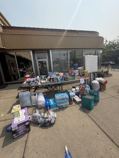 Donations to help fire survivors sit outside The Garland Theater on Monday, August 3.  