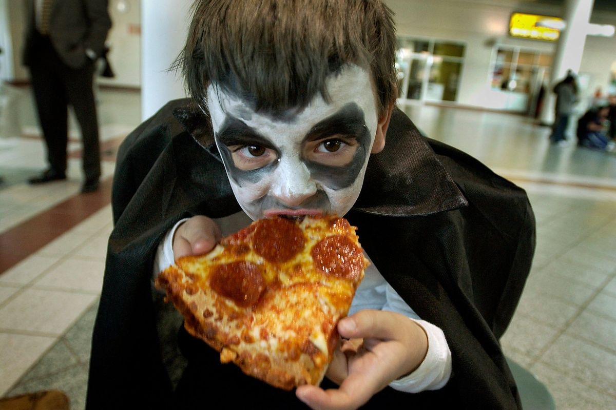 I WAAANT TO BITE YOUR ... CRUST ... Five-year-old Dracula Trevin Kretz, takes a bite from his pepperoni pizza as he waits for his brother and other members of the Chase Middle School band to perform in 2003 at the STA Plaza. Trevin wasn’t sure who Dracula is, but thought he is some kind of monster.  (Spokesman-Review Photo Archive)